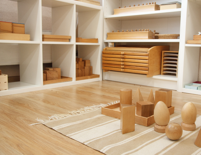 use wooden trays to store toys on a montessori toy shelf 