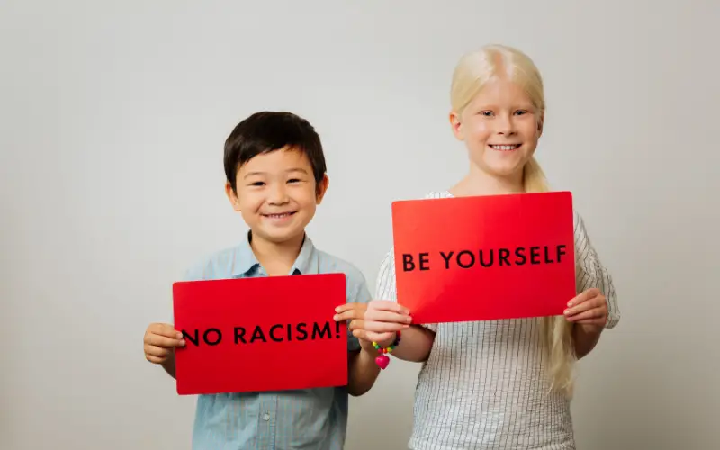 children holding signs to end racism