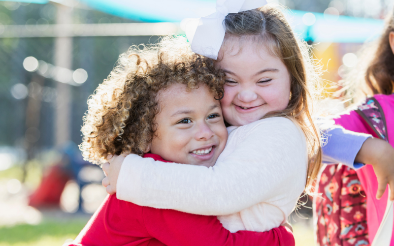 boy and girl hugging - girl has down's syndrome