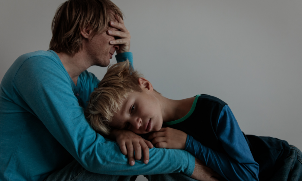 parent comforts a child, uvalde school shooting, 