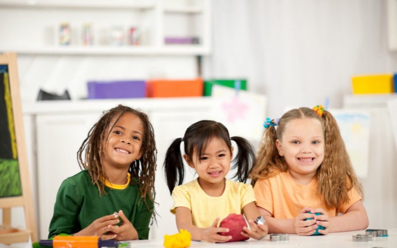 three smiling children of different races - diversity