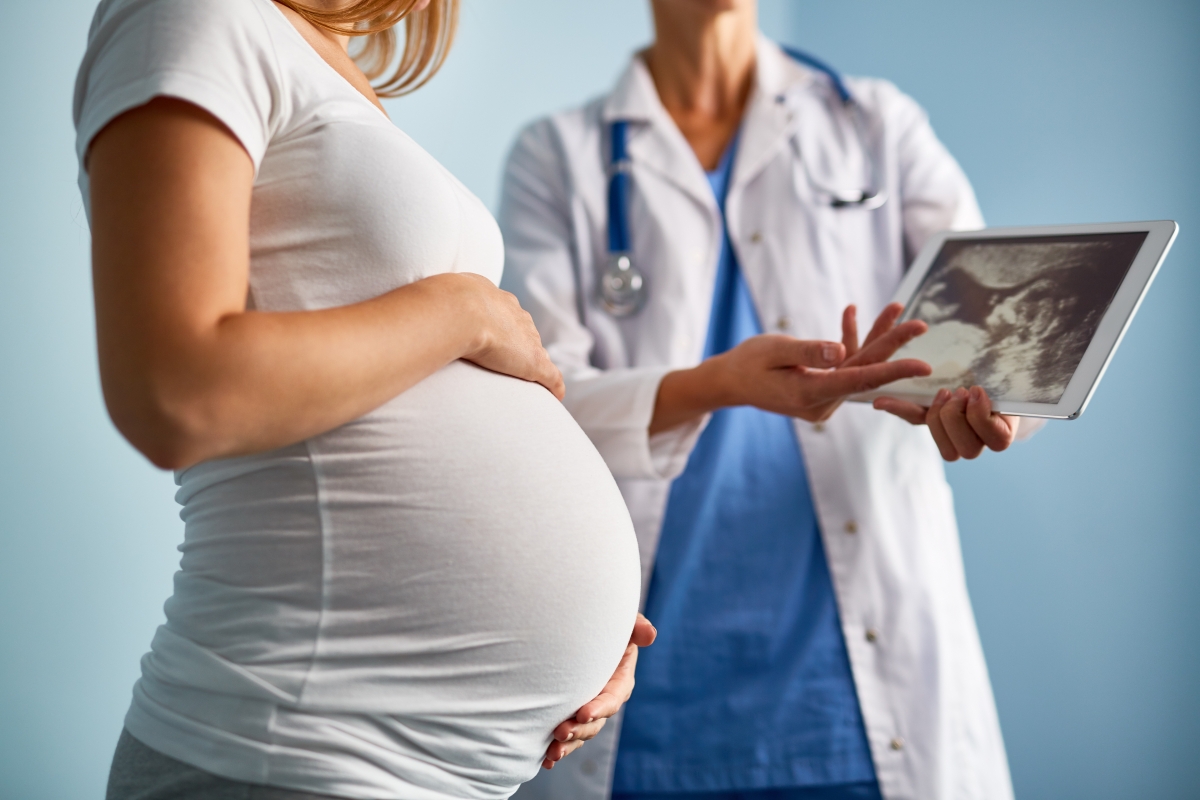 pregnant woman speaking with her doctor